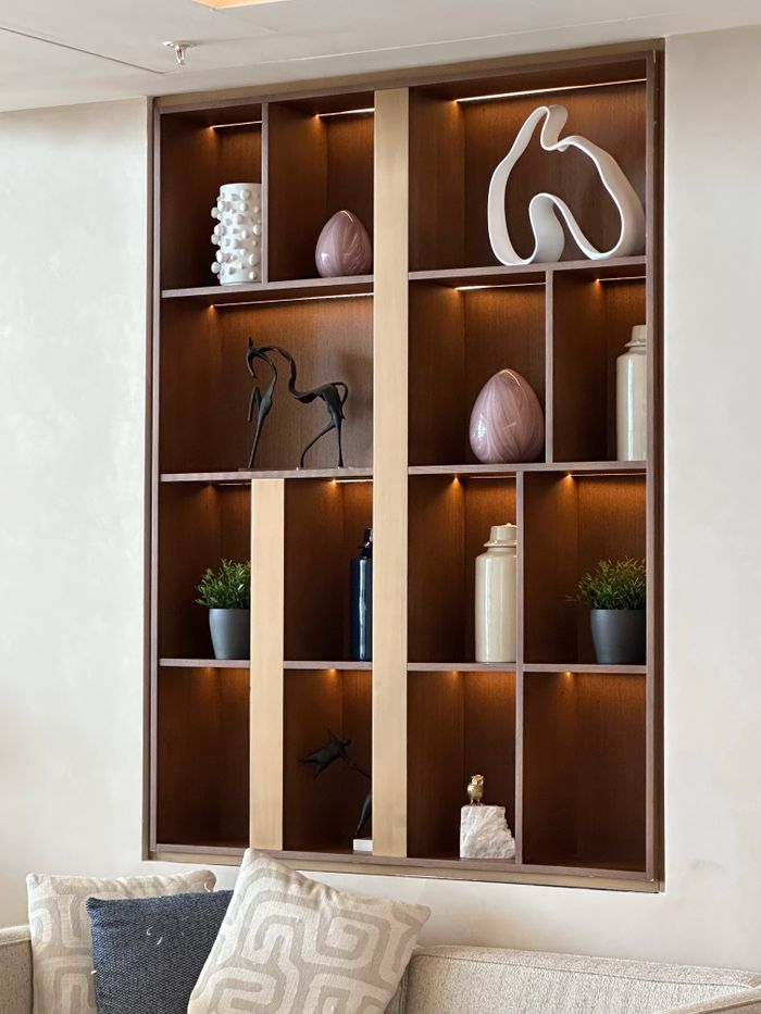 services-02 Stylish wooden wall shelf with decor items in a modern living room.