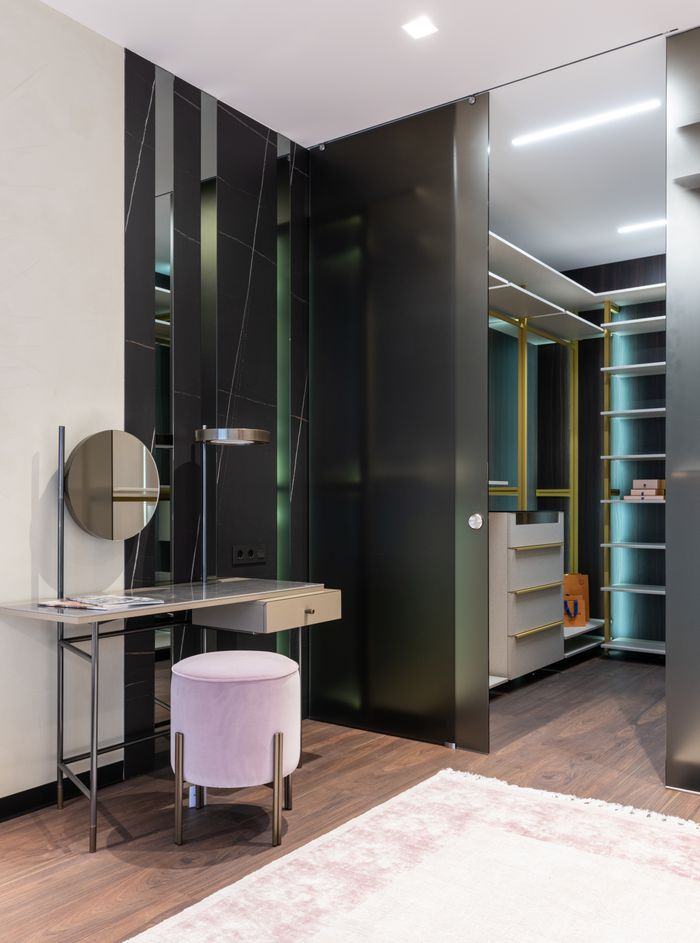 services-01 Interior of contemporary apartment with spacious dressing area and vanity table with mirror near padded stool
